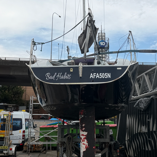 Transom of Hick 35 showing Bad Habits name and registration in white