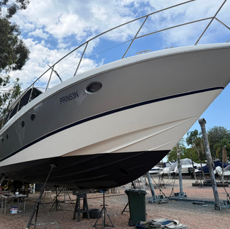 Exterior boat wrap transformation on Princess motor yacht with dark blue stripe