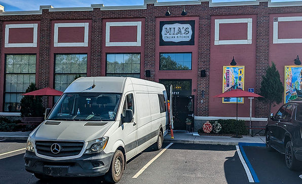 Exterior of Mia’s Italian Kitchen restaurant with a production van parked in front before a video shoot