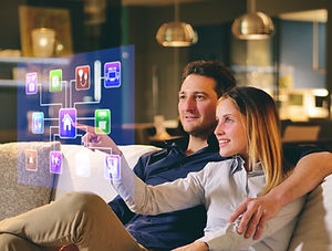 A couple sitting on the sofa controls al