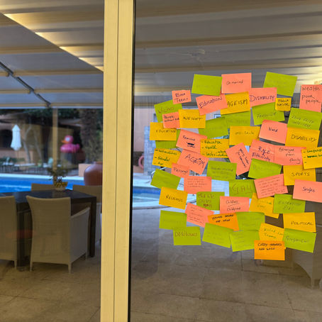 A lot of used post-it notes on a screen door with a swimming pool behind