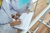 two-cropped-cardiologists-reviewing-cardiogramms-medical-office.jpg