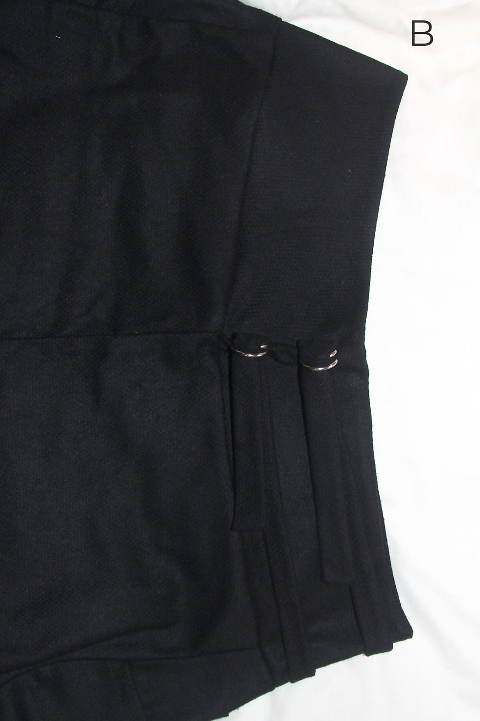 Thumbnail: close up flat lay of black wool bland one-size-fit-all trousers thick warm fabric for winter