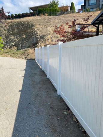 white vinyl fencing installed by blue rhino fence creates privacy for a vernon bc homeowner 