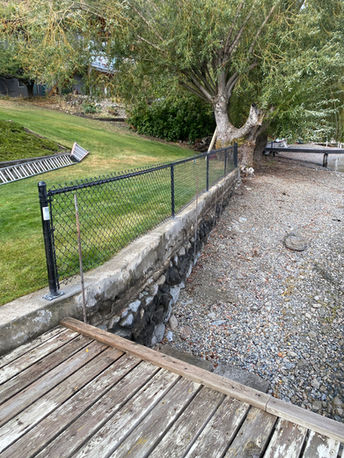black chain link fencing 3 feet high sectioning off two tiers of a backyard in kelowna bc