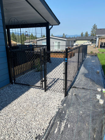 a black chain link gate and fence surrounding the backyard of a sunny okanagan bc property