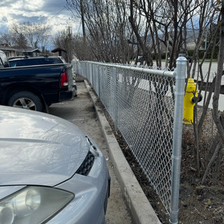 commercial chain link fence surrounding an apartment building in vernon bc built by blue rhino fence