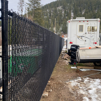 black chainlink industrial fence built for a local vernon bc business up at silver star bc