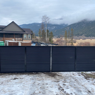custom corrugated metal black gate built by blue rhino fence in the north okanagan
