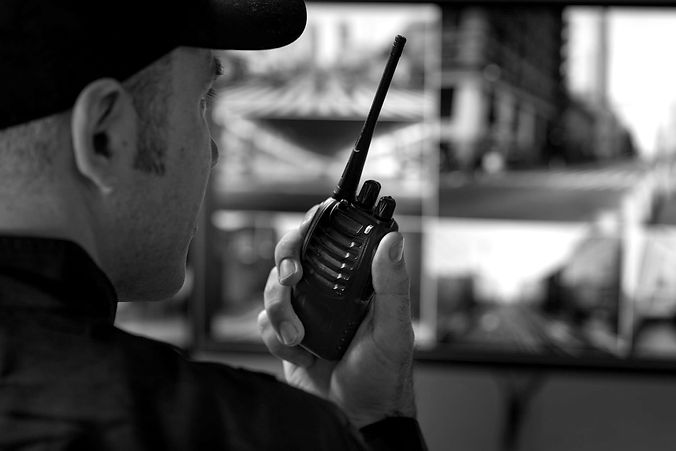 portrait-male-security-guard-with-radio-station-camera-screens_edited.jpg
