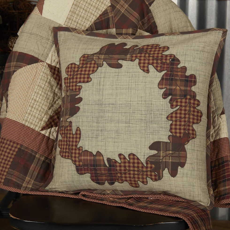 Pillow with appliquΓ©d fall leaves into a wreath shape on a tan background