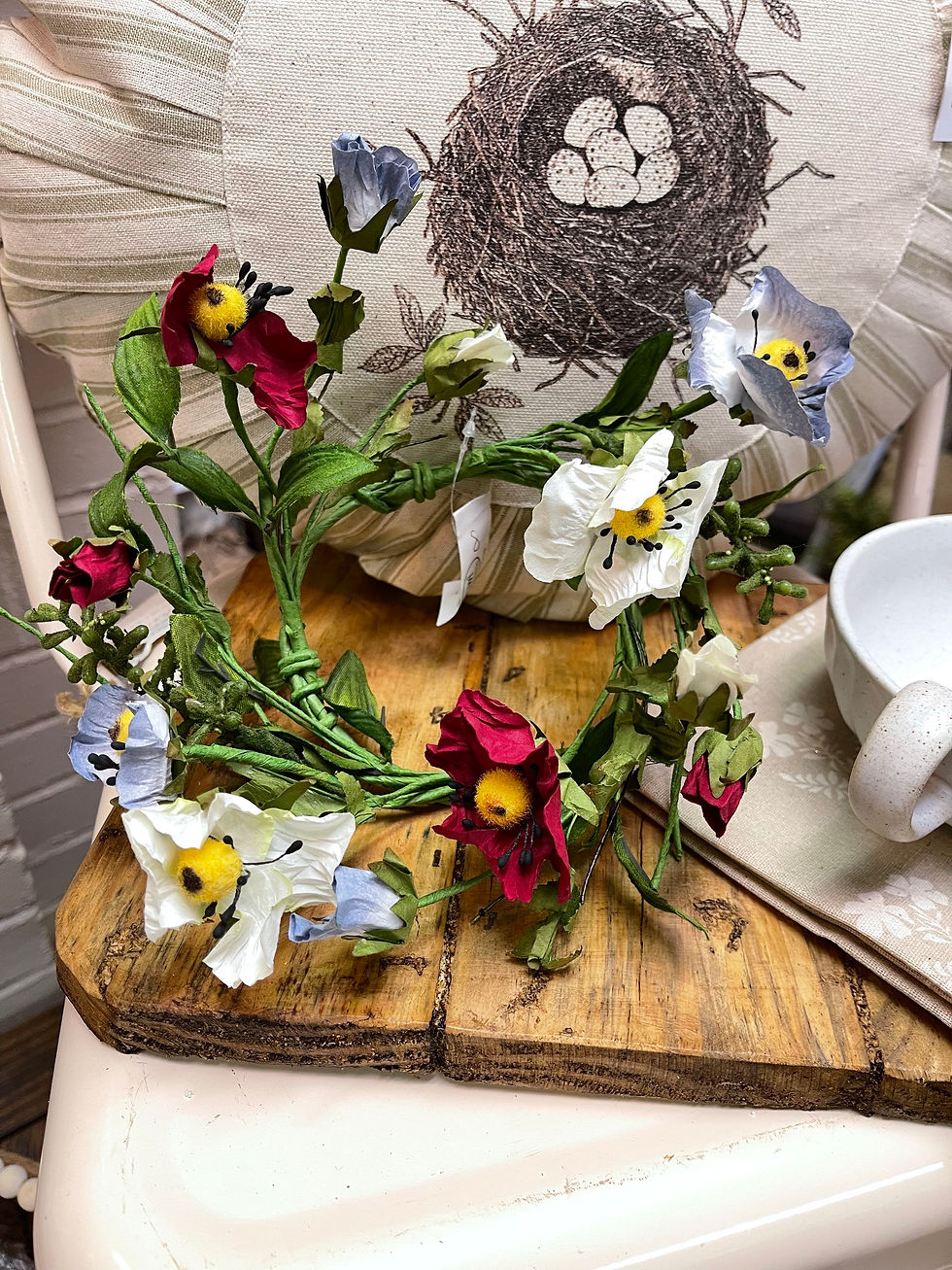 Candle ring in blue, wine, and cream paper poppies. 8" outside diameter and 3.5" inside opening