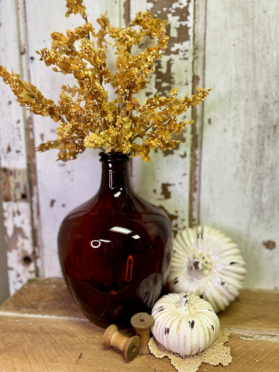 13" tall x 8" diameter glass bottle with narrow neck, amber colored