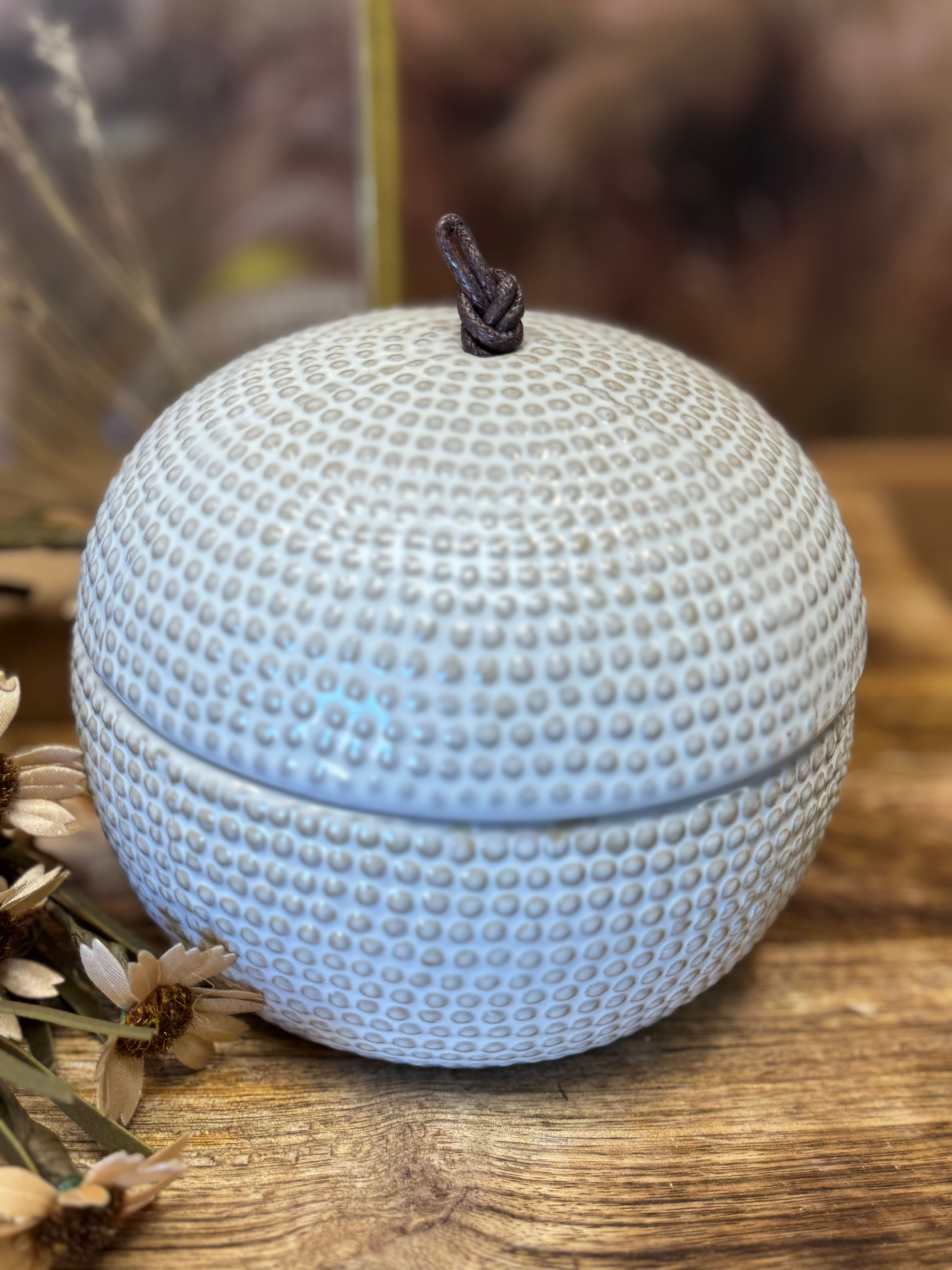 5" x 4" ceramic round pot with lid, small raised dot design, white glaze, with brown cord knot for handle on top of lid