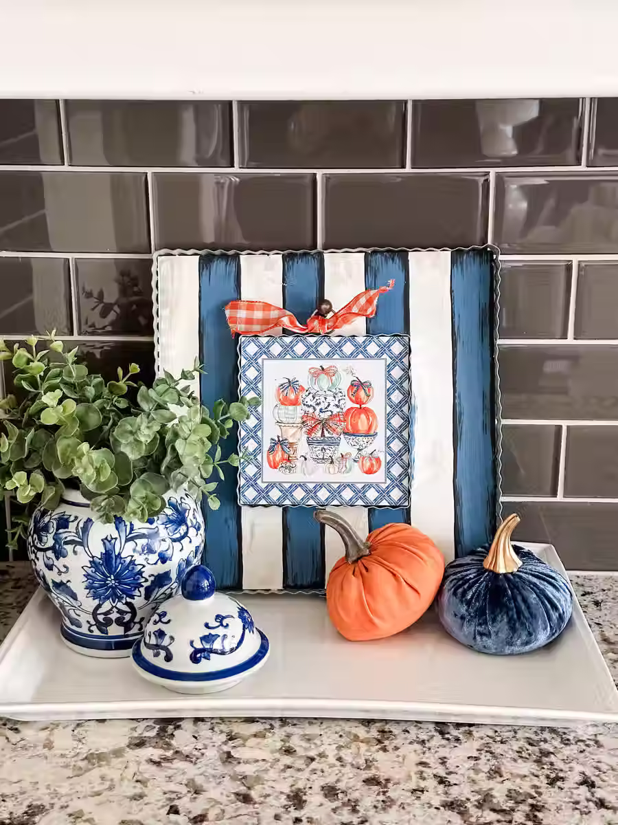 6" x 1" x 7" Round Top Collection print of a pumpkin topiary in blue pot, corrugated metal frame, ring on top for hanging