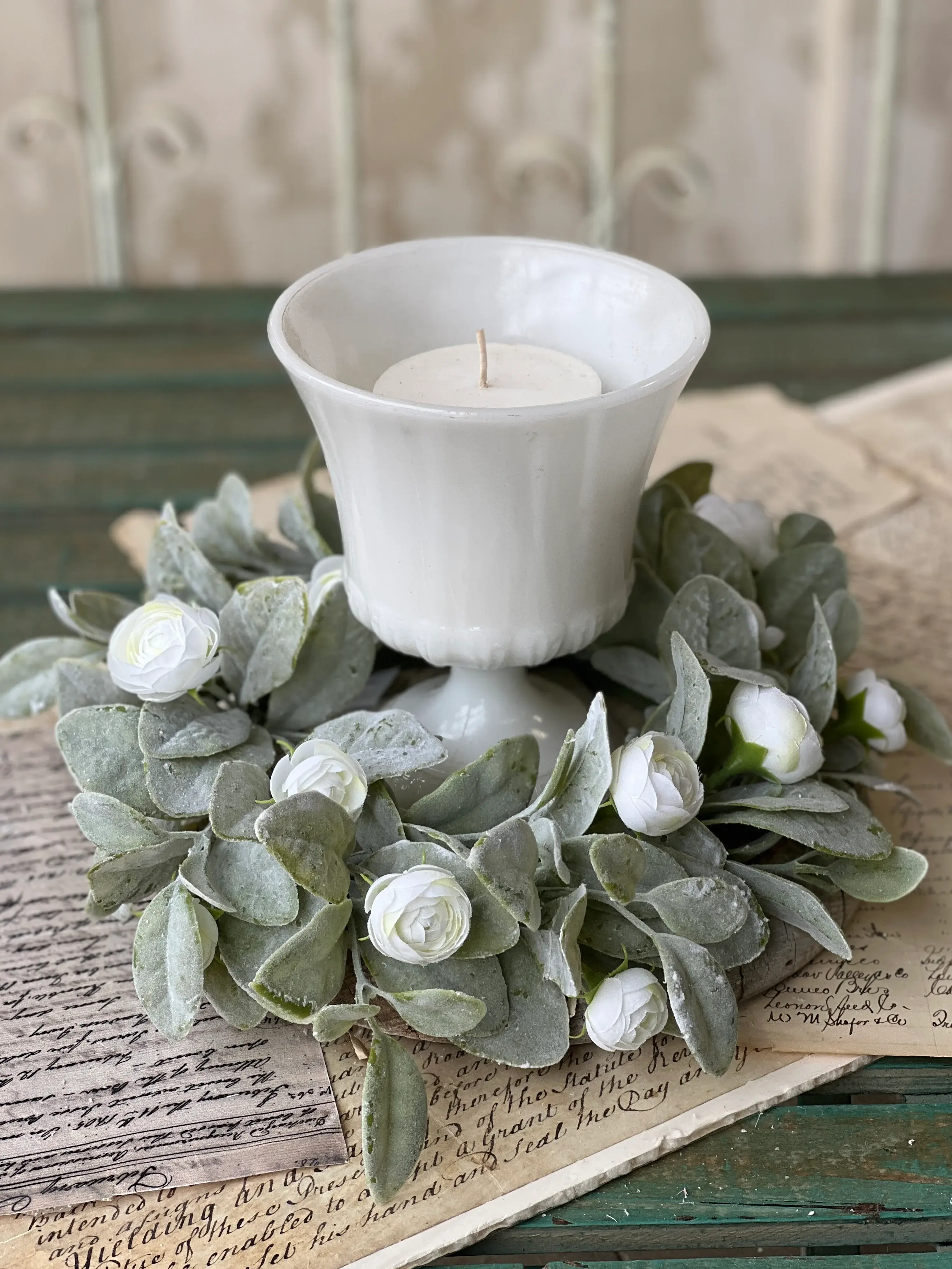 12” outer diameter 6” inner diameter candle ring of dense soft green flocked leaves and cream camellia florets