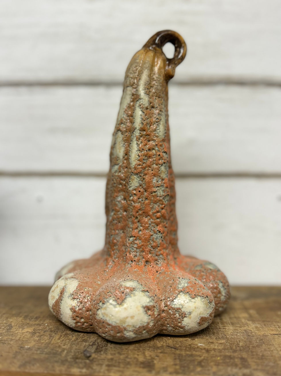 4" dia x 7.25" H Stoneware gourd with a rustic textured finish, dark orange, green & brown