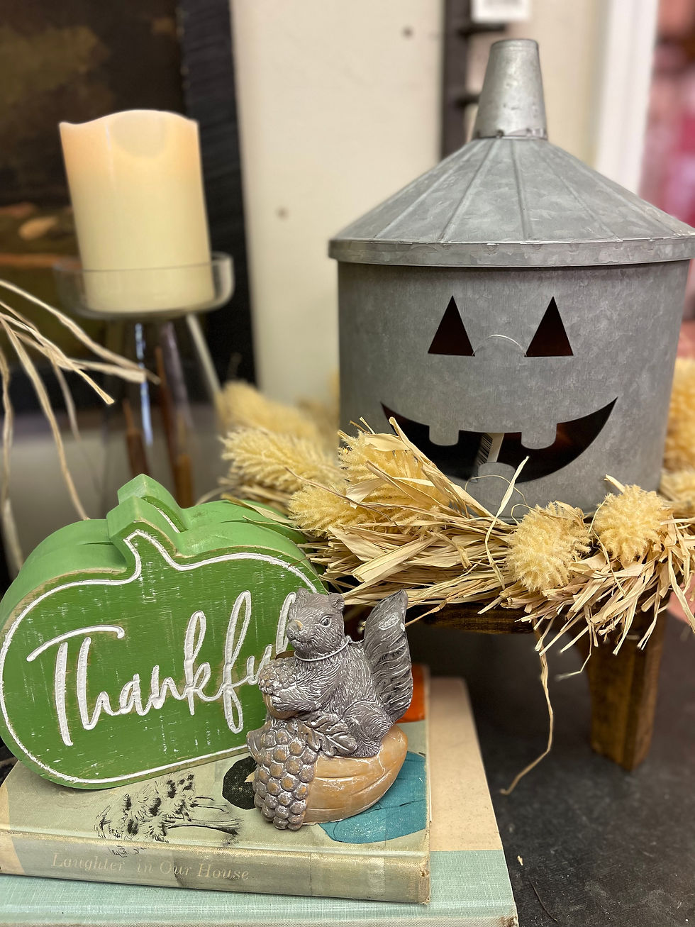 Green wooden pumpkin shaped block with the word thankful carved in the front