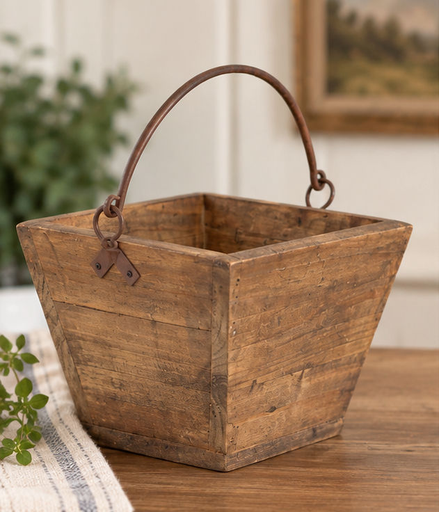 Small 9 inch wood basket with warm natural finish and curved rustic metal handle.