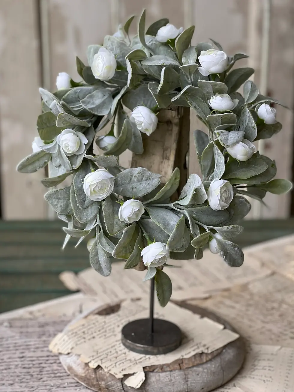 12” outer diameter 6” inner diameter candle ring of dense soft green flocked leaves and cream camellia florets