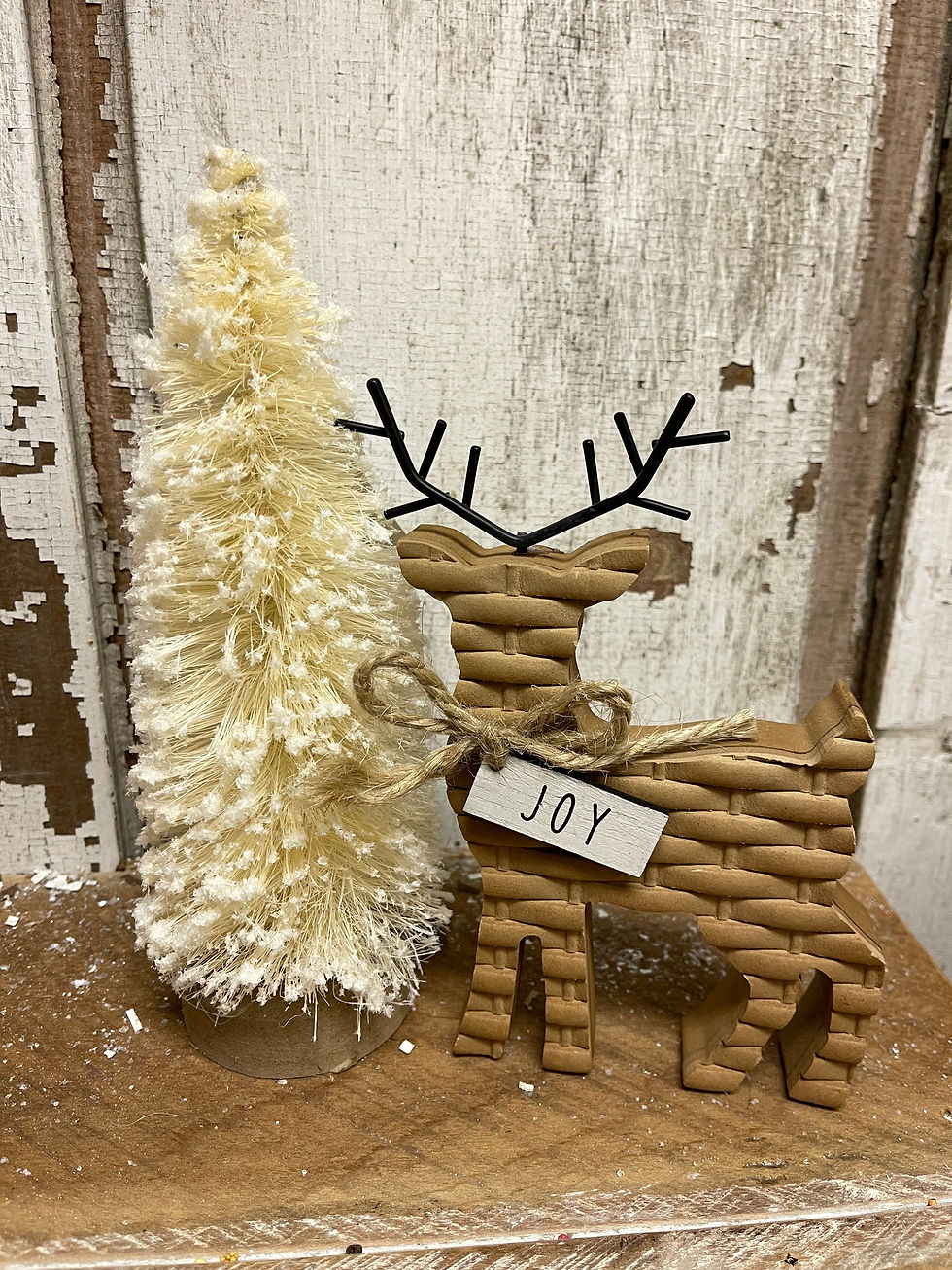 flocked cream bottlebrush tree 9” tall on wood slice base