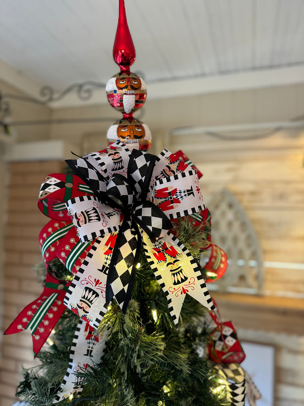 13" tall double ball glass tree topper, spire on top, balls have nutcracker faces main color is red