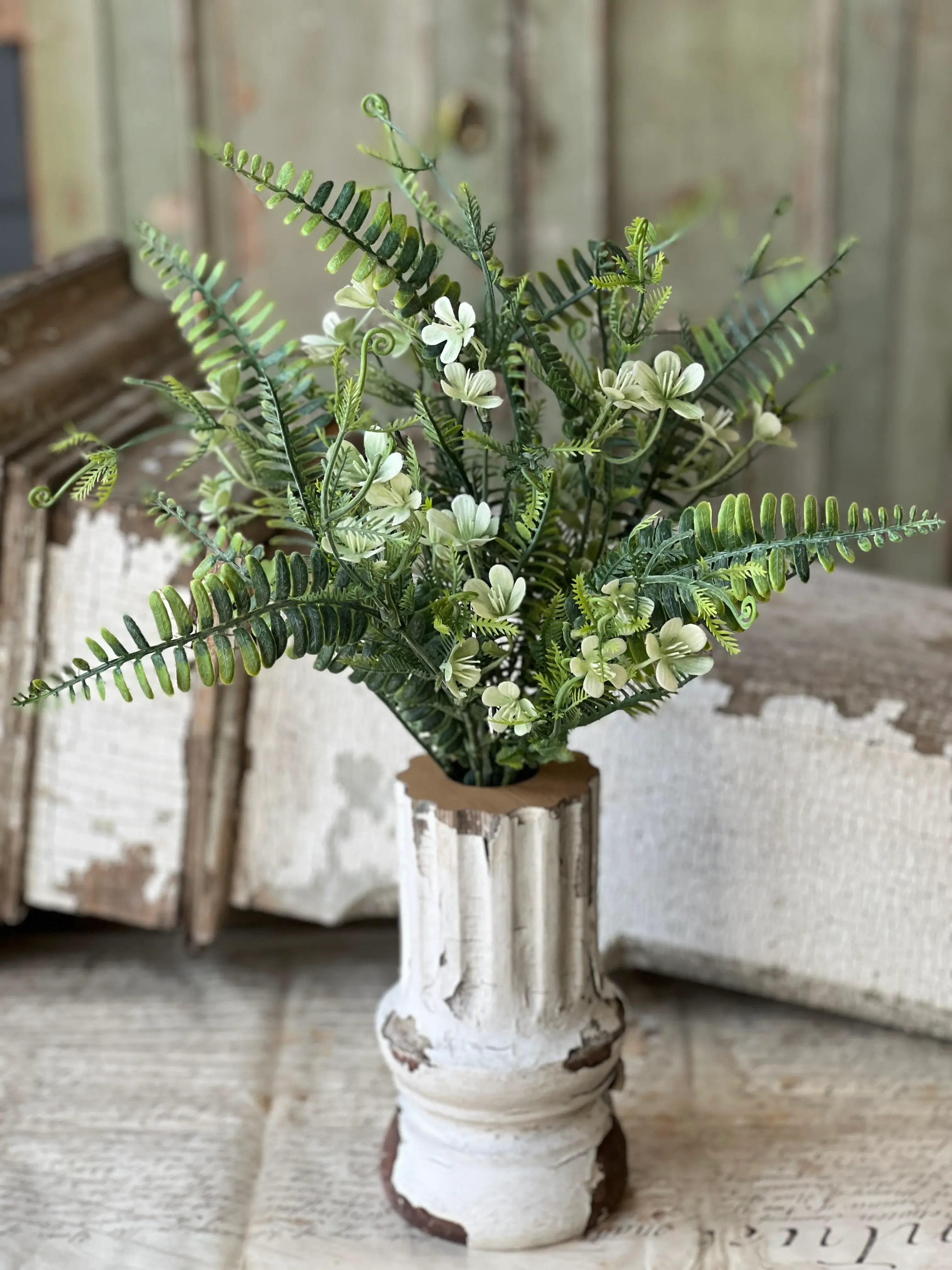 19" tall bush filled with trailing tendrils and airy foliage mixed with fern greenery interlaced with pretty cream blooms