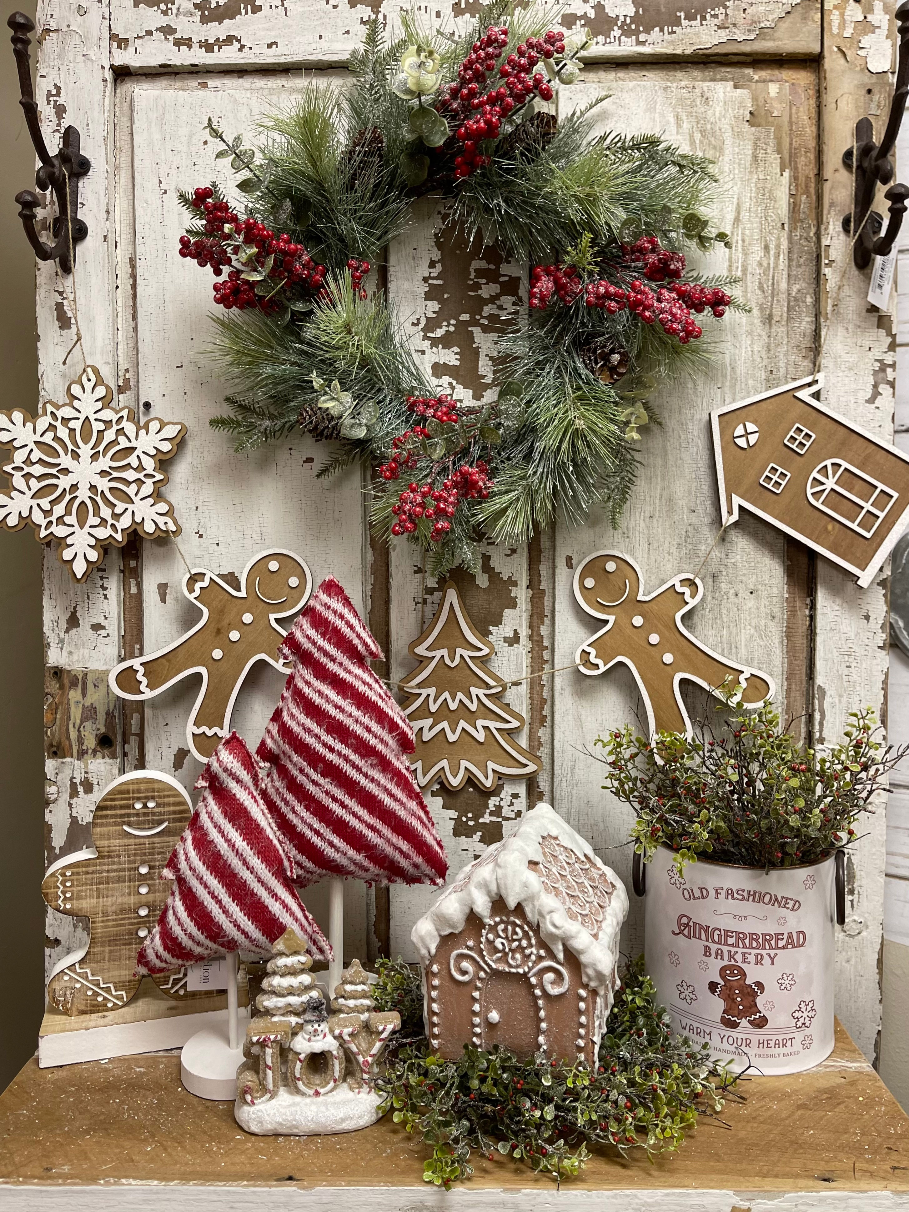 Wood Gingerbread cookies shaped like a man, house, and snowflake strung onto jute to make a garland