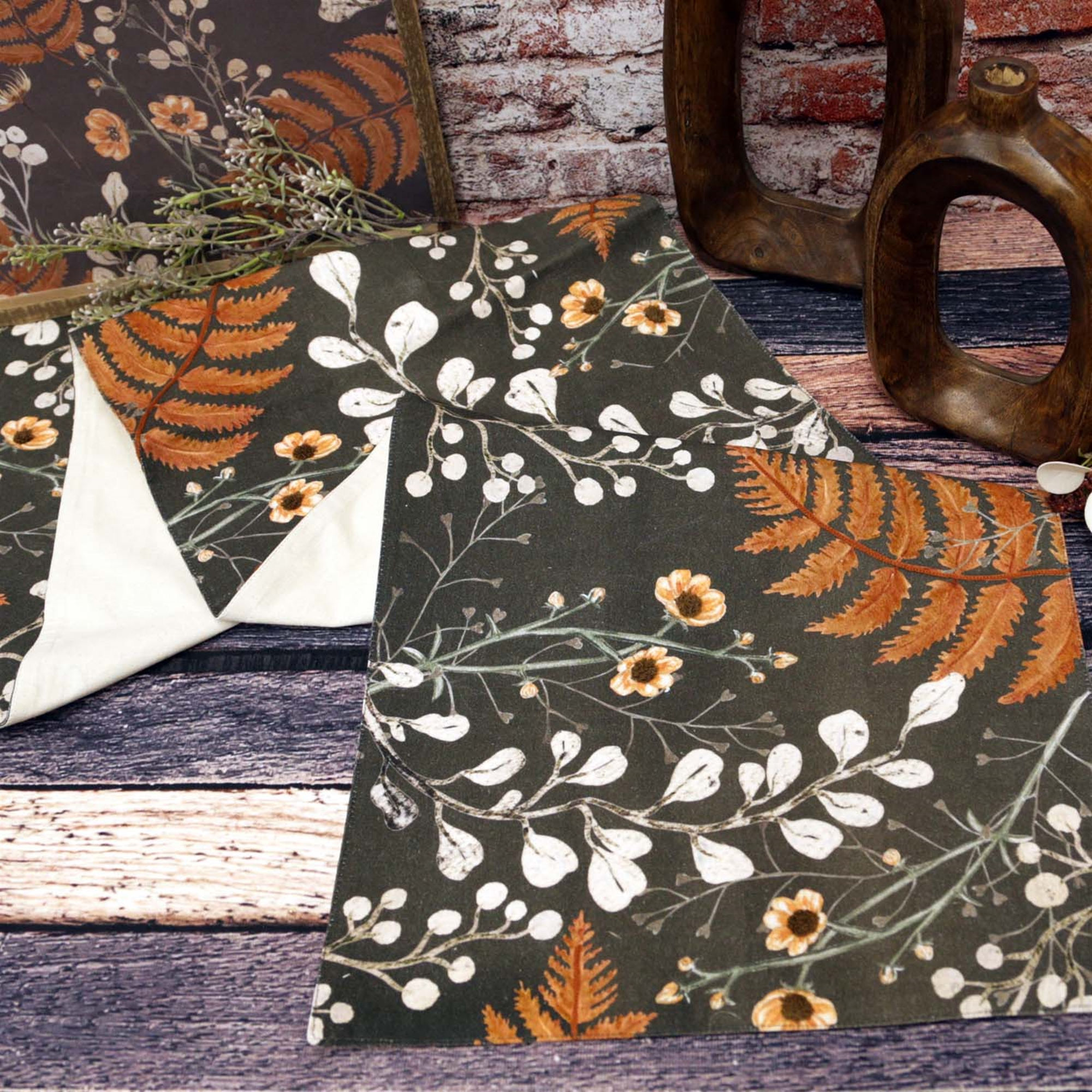 15" x 56" black cotton table runner with flowers, foliage & ferns in tones of soft green, terracotta & cream