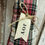 Thumbnail: 19.5" H x 9" W x 2.5" D candy cane shaped pillow in red plaid flannel, tag that says JOY