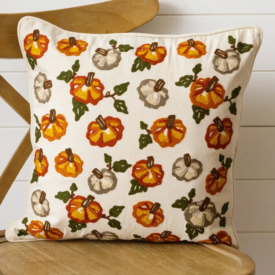 Natural canvas pillow with green, orange and white pumpkins embroidered on front