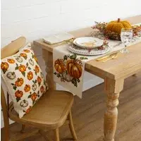 Natural canvas pillow with green, orange and white pumpkins embroidered on front