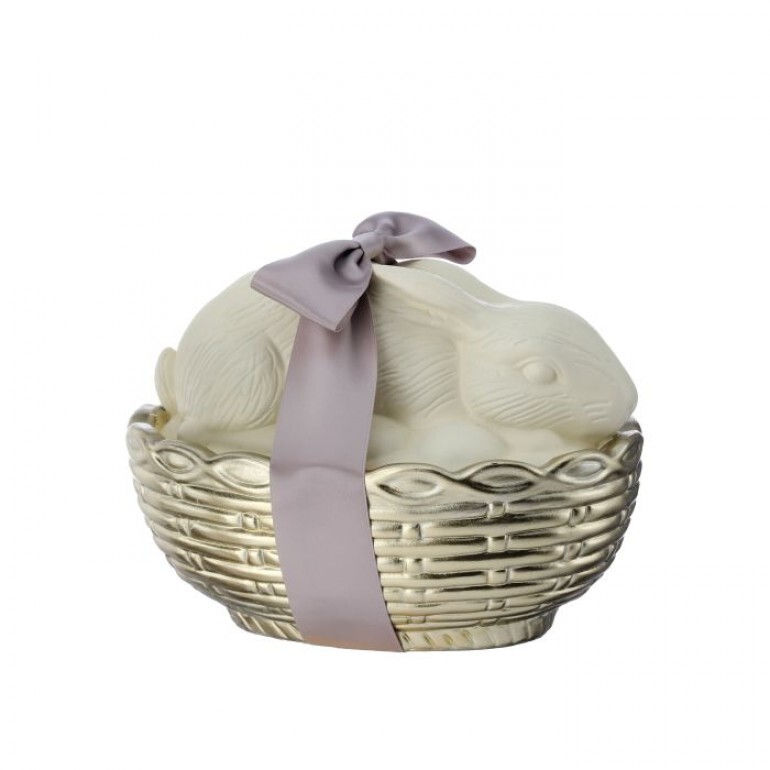 8" resin figurine, white chocolate bunny laying in a gold basket, tied with a smokey lavender satin ribbon