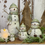 Thumbnail: 3" tall mini resin snowman wearing green sock hat & scarf, brown wrapped wire arms