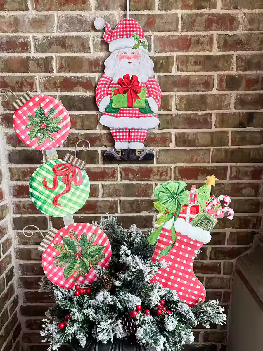 11" X 22" PVC cutout Santa Claus holding a present door hanger from Round Top Collection