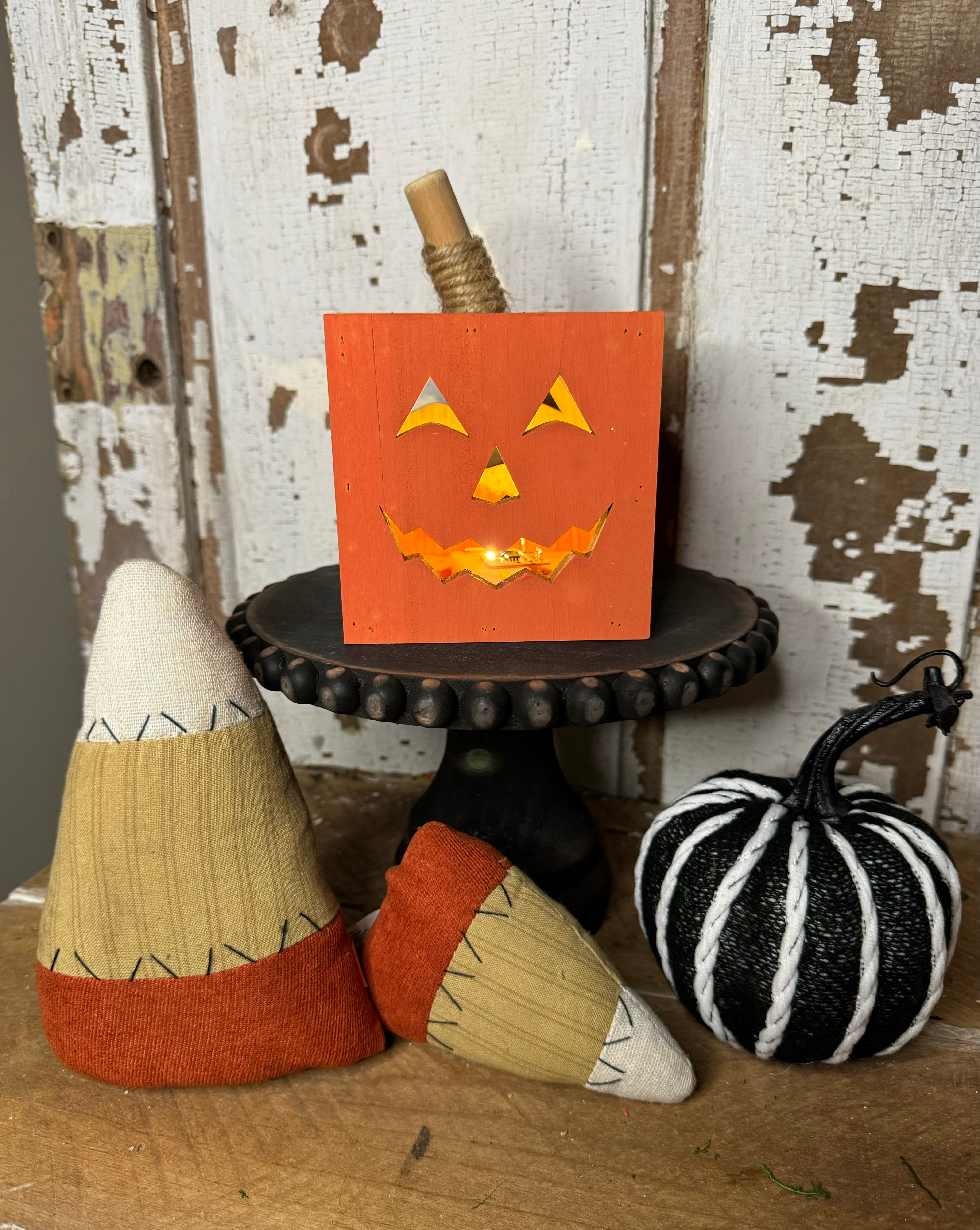 4" square x 5.75" tall orange wood box, cut out jack o' lantern face front & back, inside battery operated light, 6 hr timer
