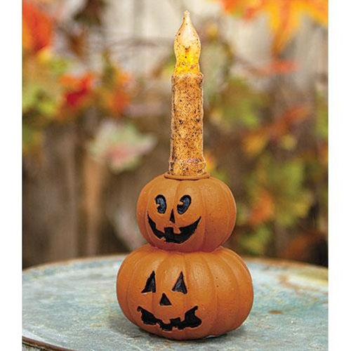 4.25” x 3.5” resin taper candle holder in the shape of 2 stacked orange jack o’ lanterns