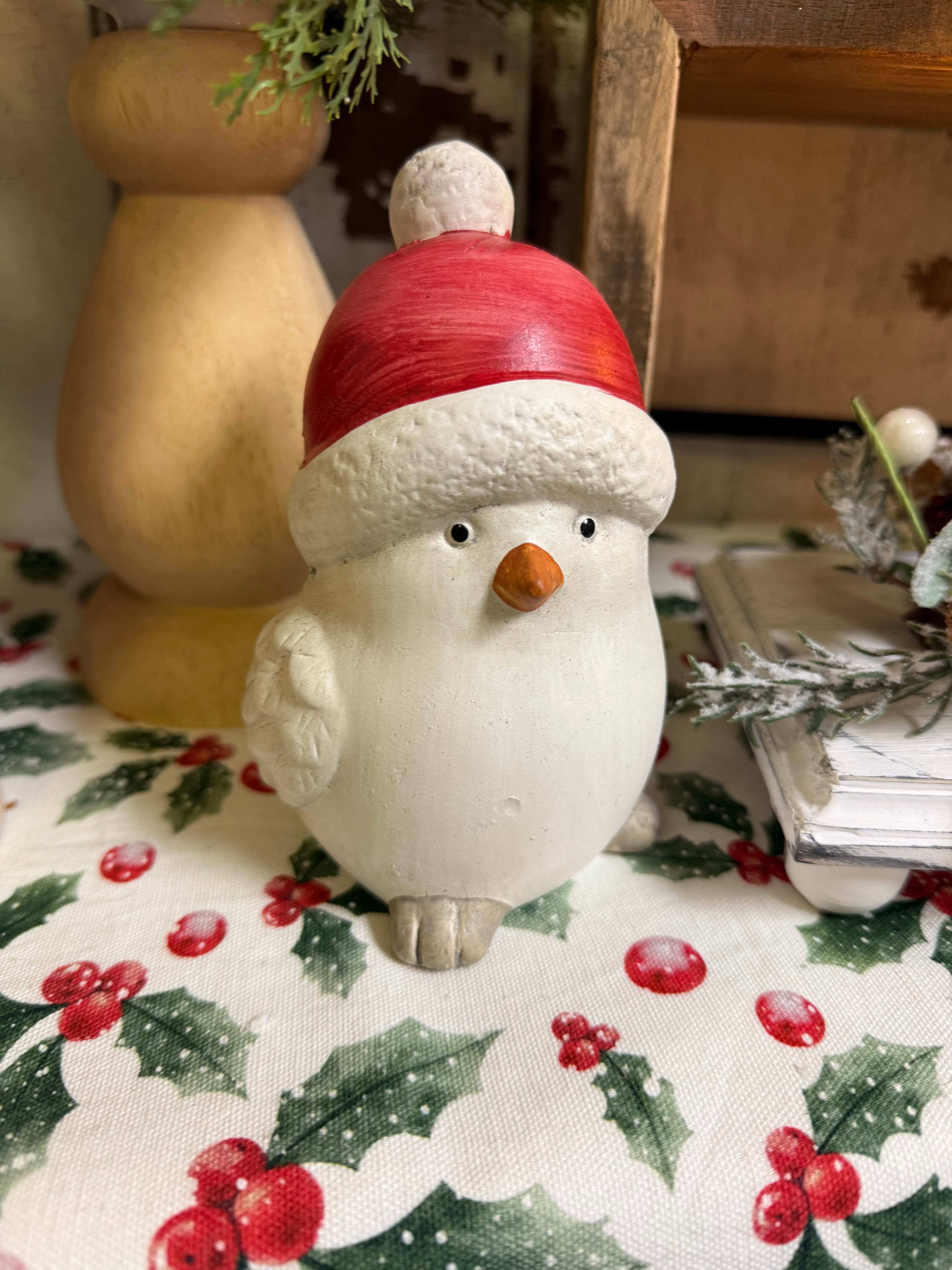 5.7" tall resin white bird wearing a red and white sock hat