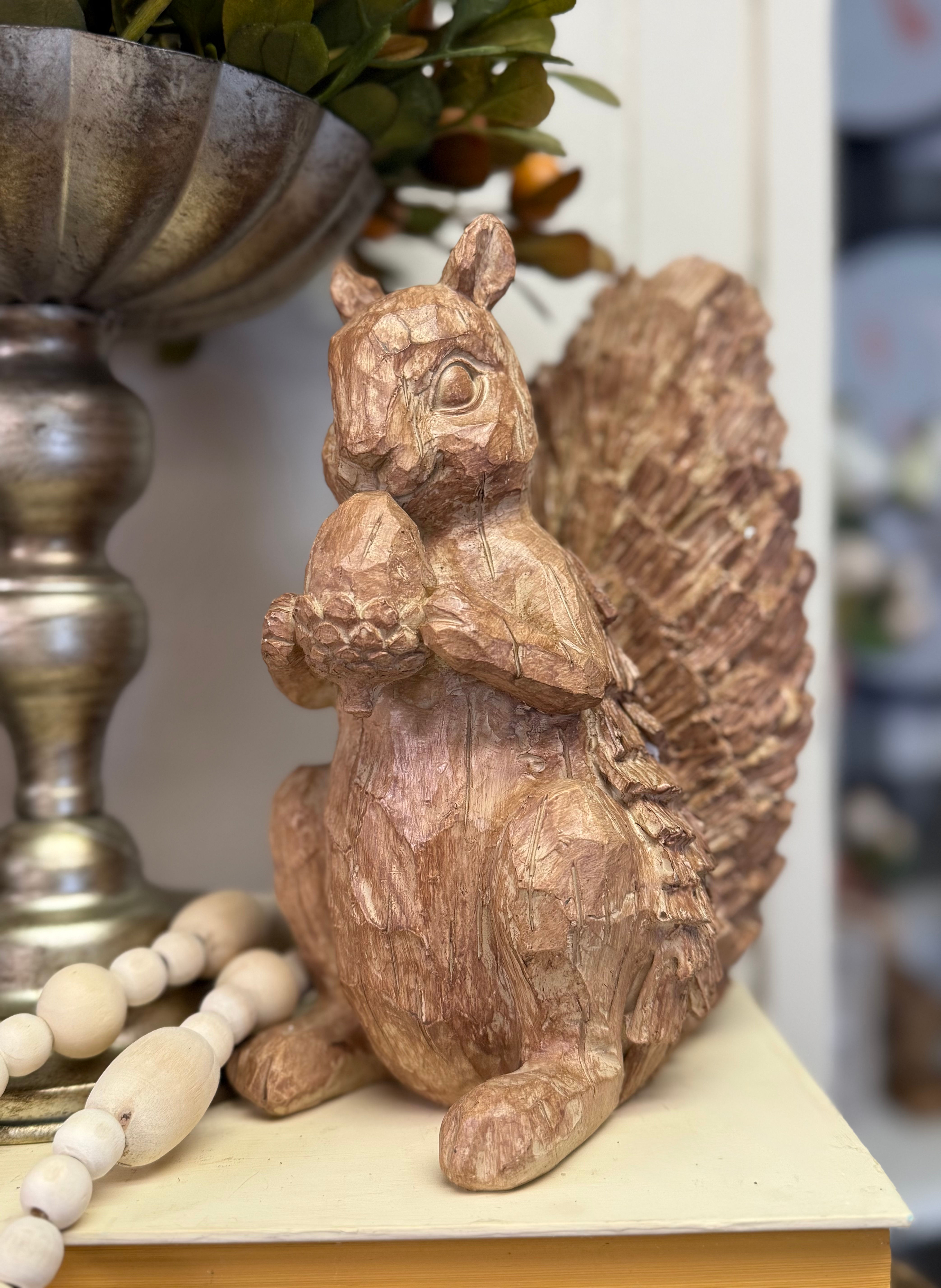 8" x 7" resin squirrel, standing holding an acorn, looks like carved wood