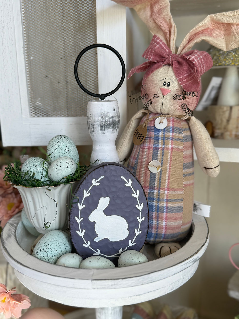 3.5” x 1” x 4.5” resin flat egg shaped figurine, dusty lavender, carved out sitting white rabbit silhouette in laurel wreath