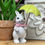 Thumbnail: 7" tall white resin bunny, standing & holding a yellow umbrella