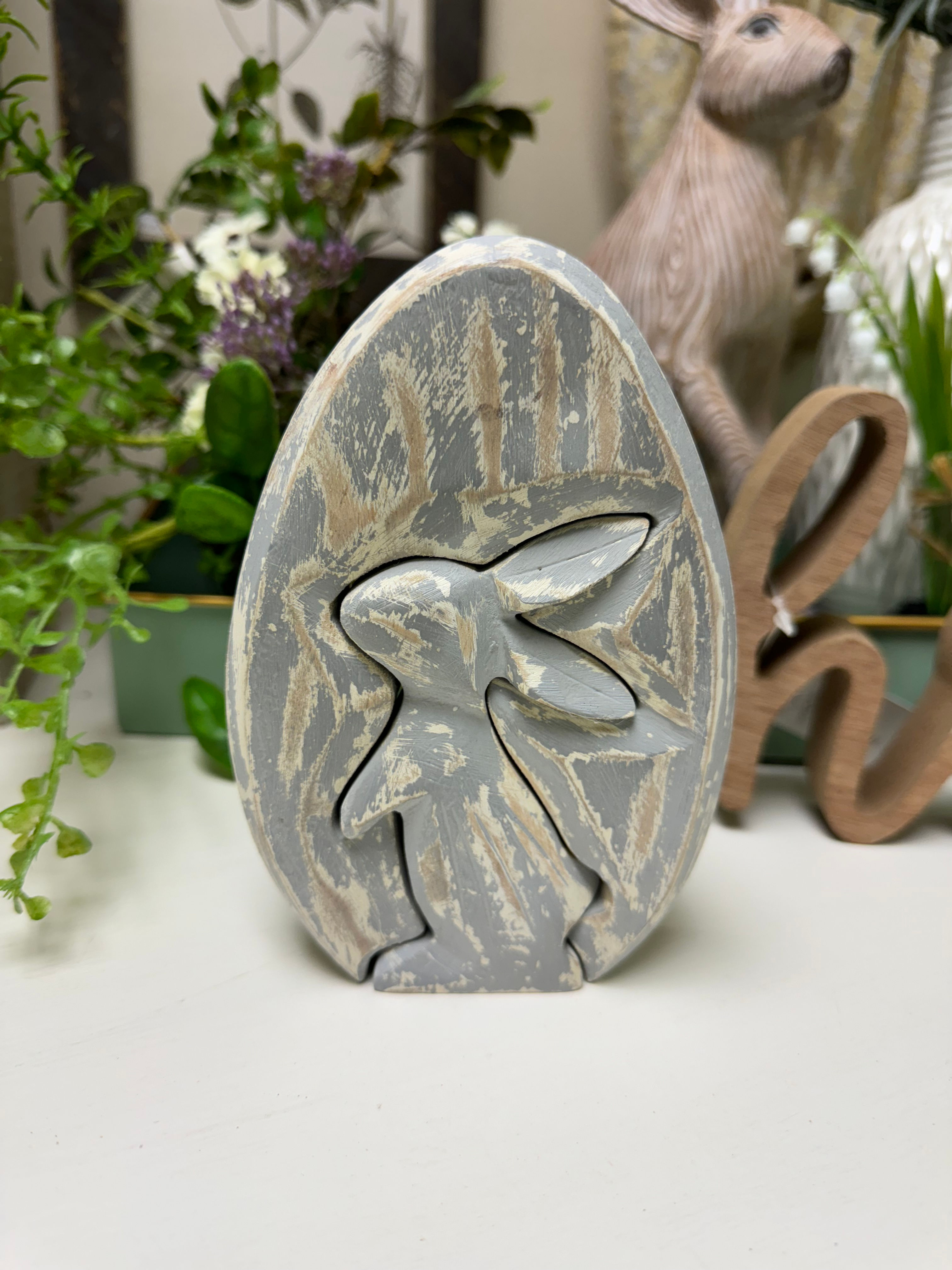 4” x 1” x 6” wood egg with cutout bunny that is removable like a puzzle piece, distressed gray