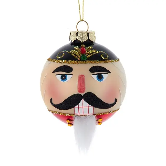 4.9" x 4.1" x 3.5" glass ornament painted with a nutcracker face accented with jewels, gold glitter & beard