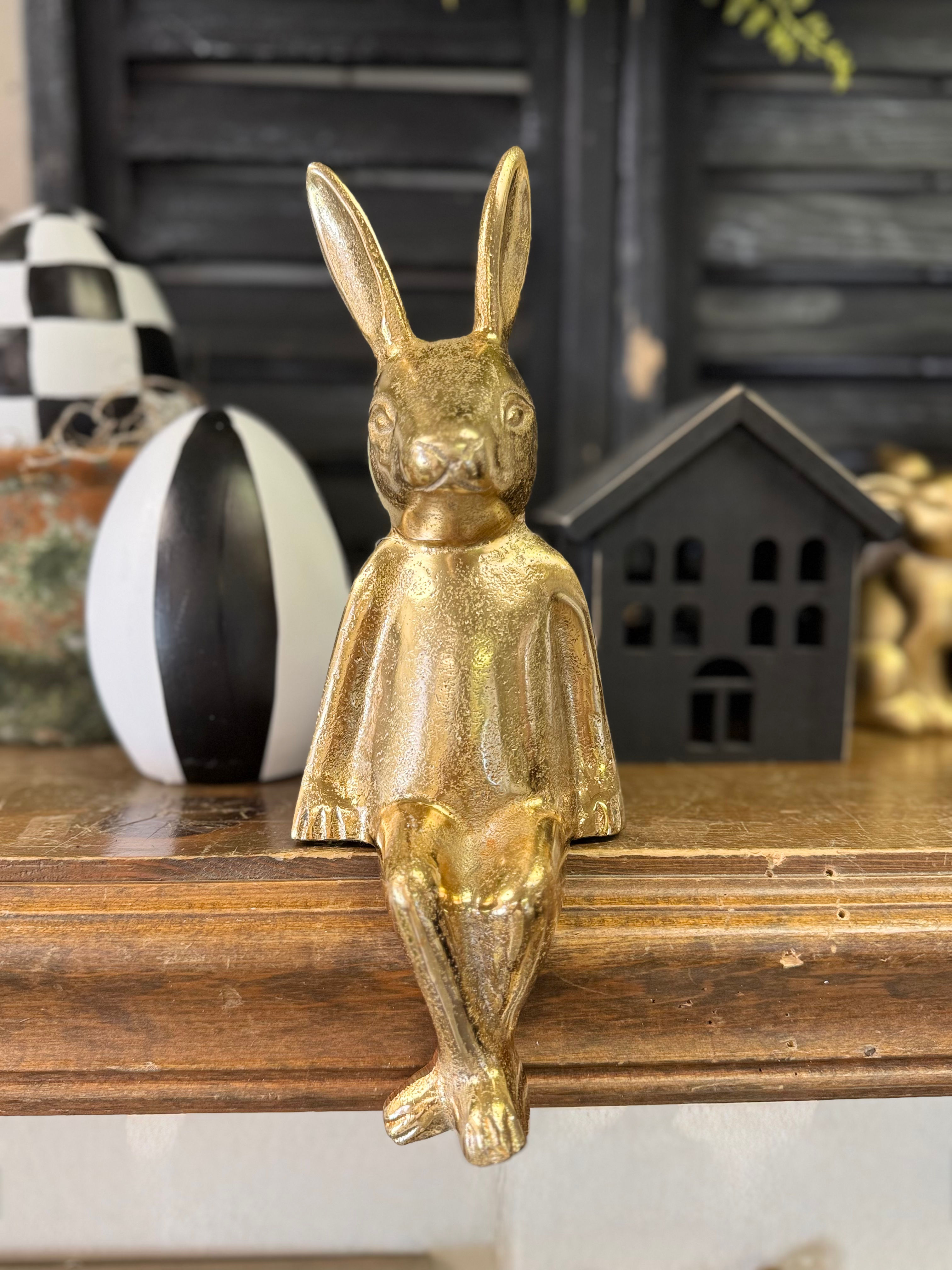 11" tall metal bunny rabbit with gold finish, in a sitting position, sits on edge of shelf or table