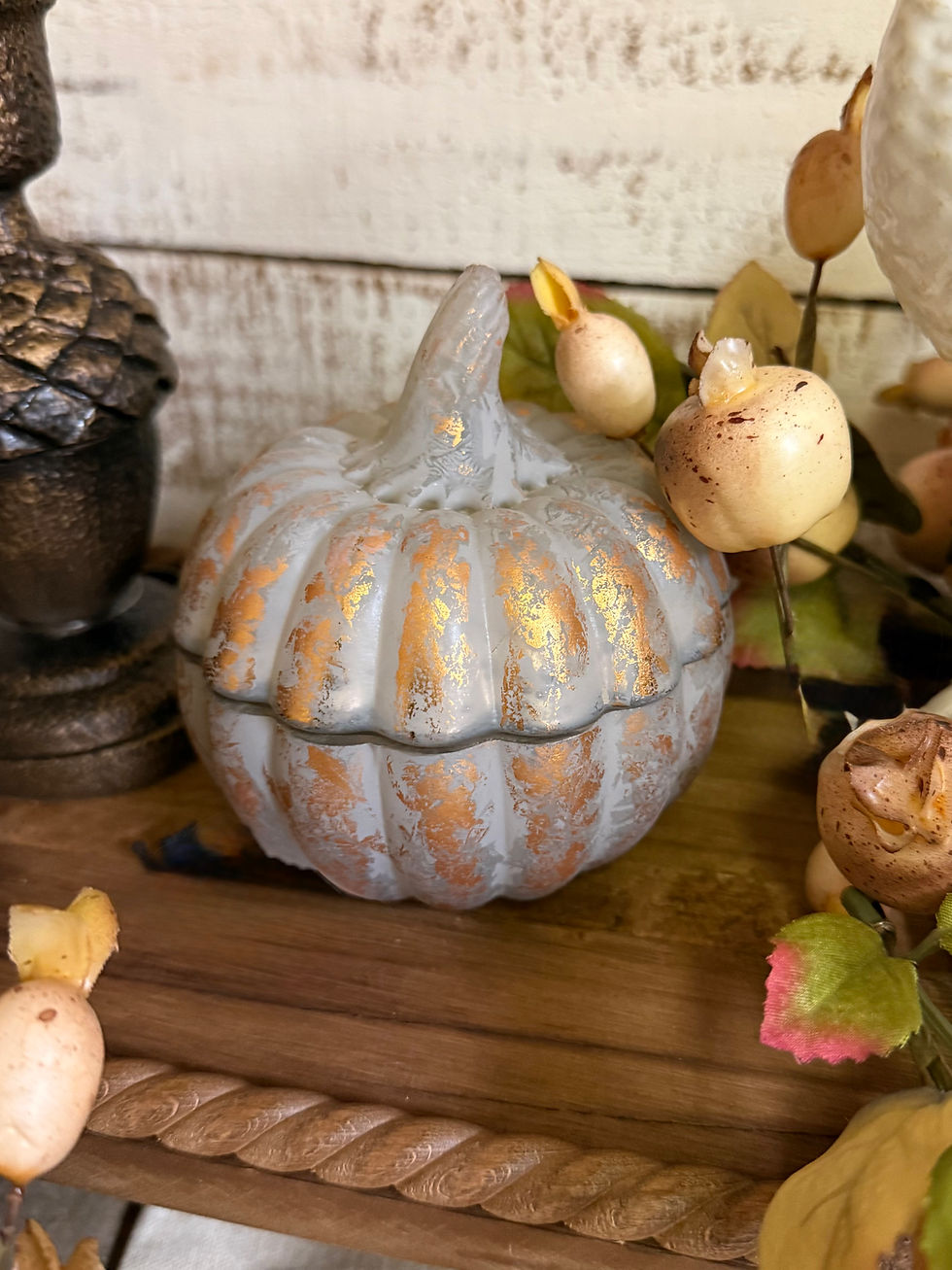Pumpkin Spice poured candle in a matte decorative pumpkin vessel with warm gilded gold accents.