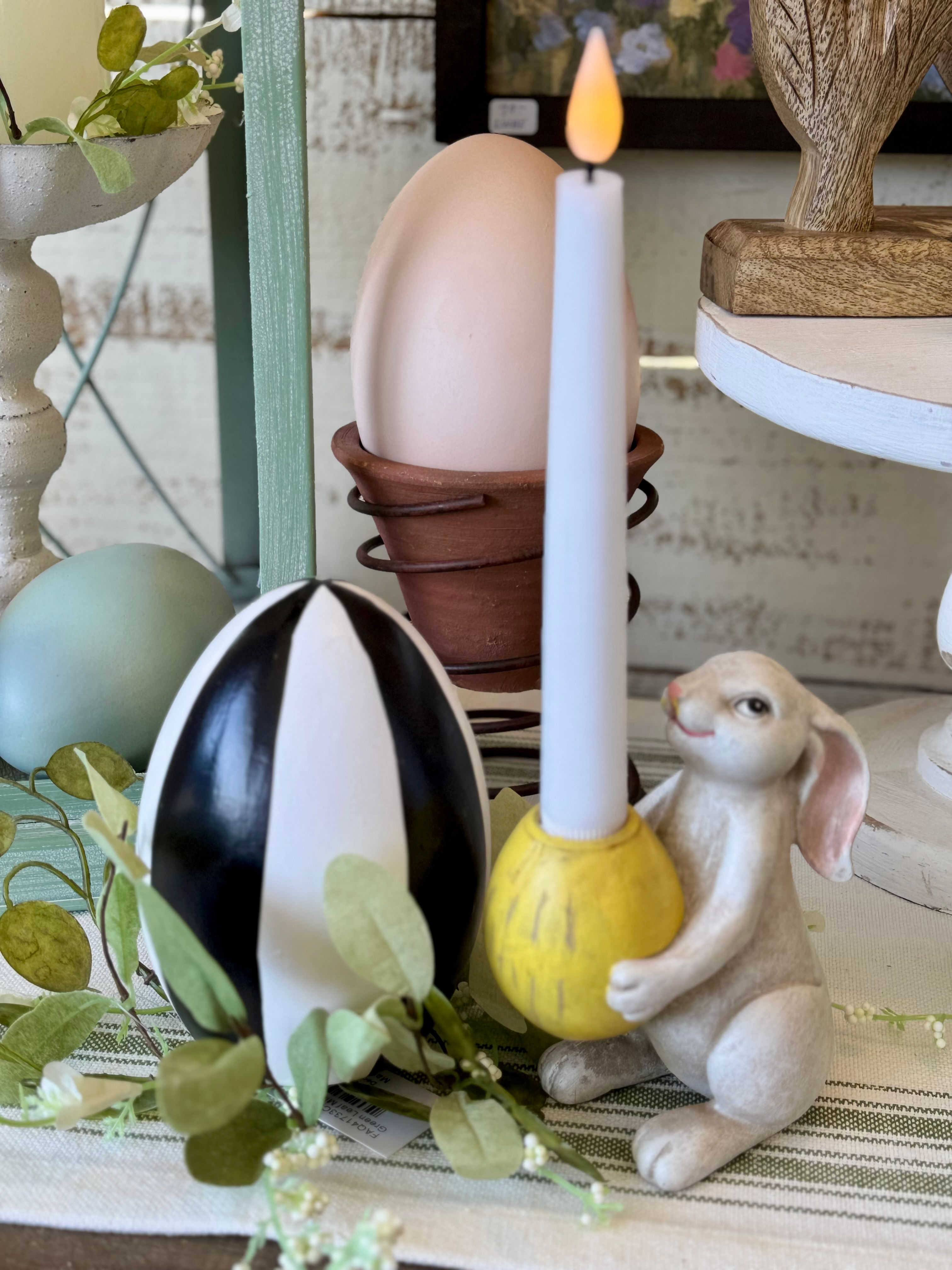 5.5" resin antiqued white bunny holding a yellow egg, egg is a taper candle holder