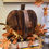 Thumbnail: 4.5" inner opening diameter candle ring of fall florals in golden yellows, rich rust & olive green tones.