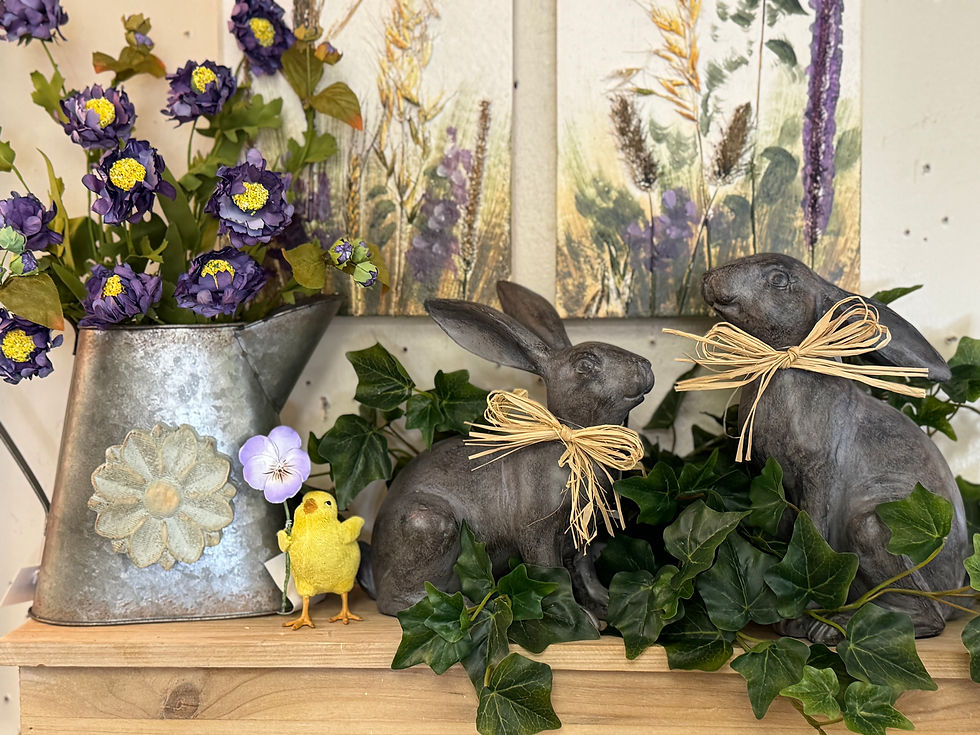8.5" H x 8" W x 4" D polyresin & stone powder rabbit with charcoal finish & raffia bow around neck