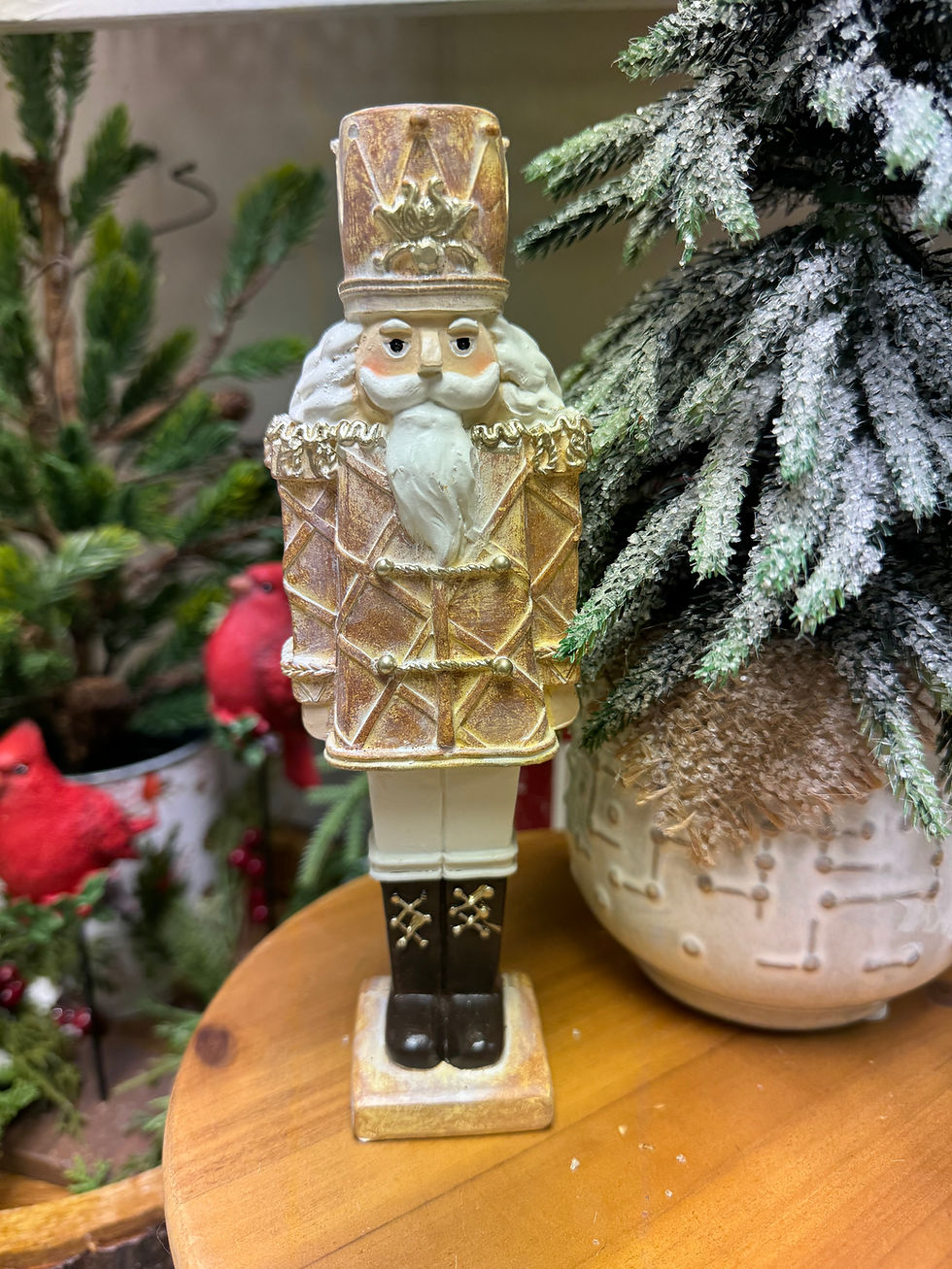 8" tall x 2.25" wide resin nutcracker in brown, cream & white tones