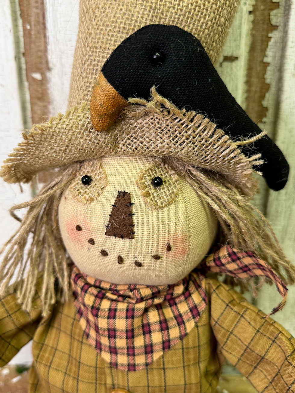 Thumbnail: 15" x 5" x 19.5" fabric stuffed scarecrow wearing burlap hat with stuffed crow, plaid shirt, green pants & jute hair